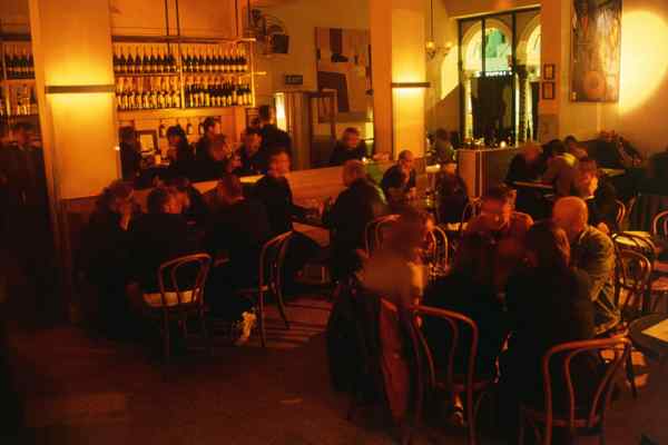 People crowded inside a Melbourne bar enjoy a drink