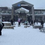 mt buller main lodge and entrence building covered in snow and people